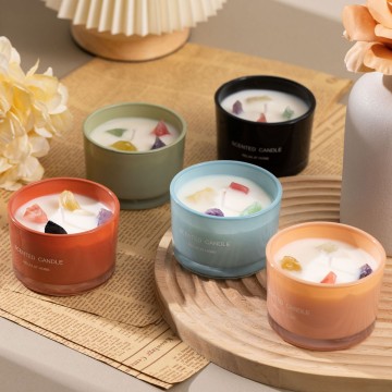 The scented candle is decorated with crystal stones